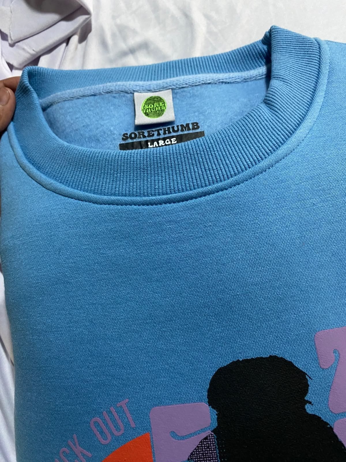 Custom crewneck sweatshirt, neck tag detail