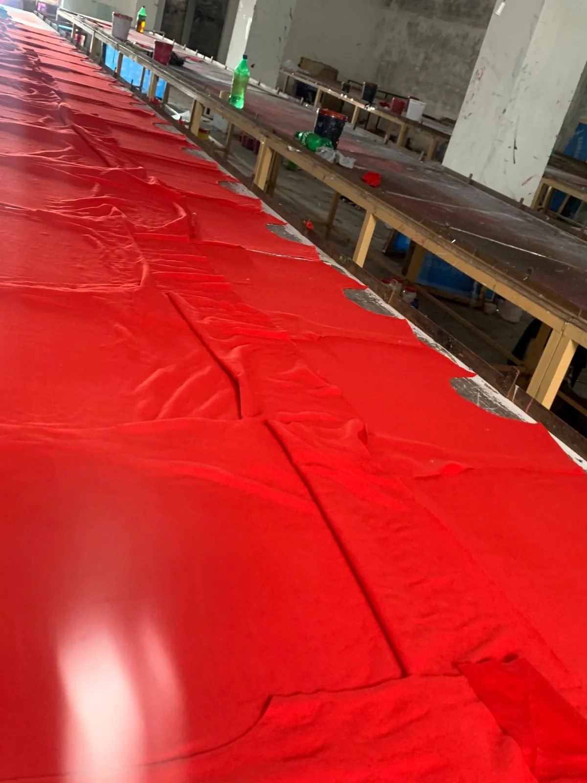 Fabric laid out on the cutting table at the Nyxlete workshop